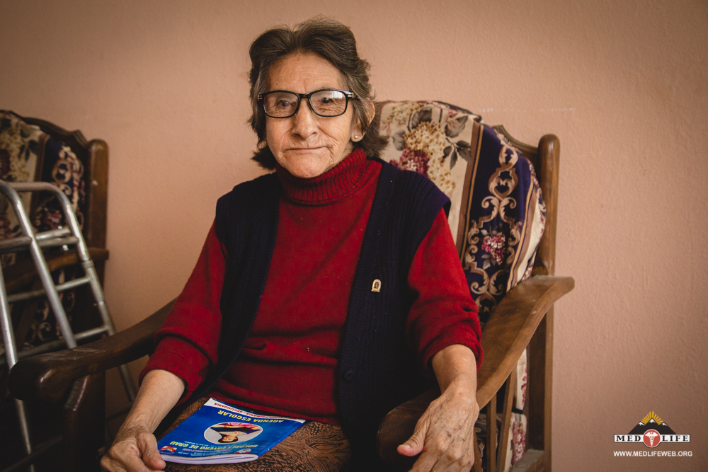 Catalina, a follow-up patient originally from Cusco, poses with one of two brand-new pairs of glasses delivered during a follow-up visit.