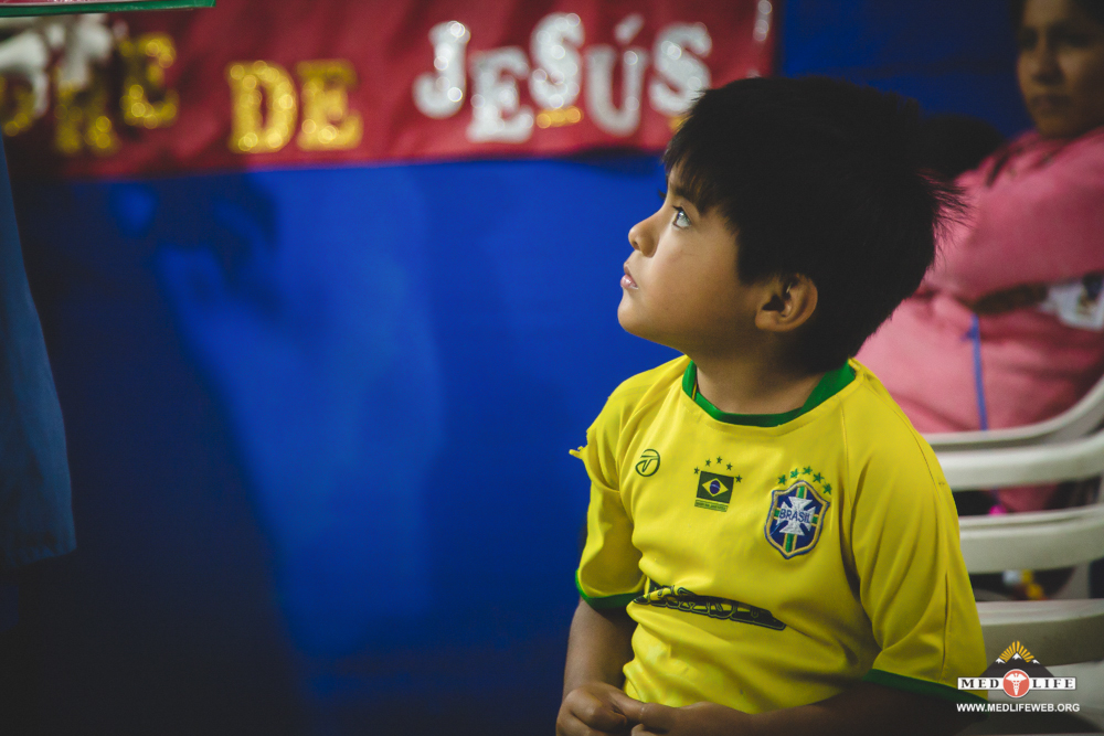 A little boy gives his full attention during a community education session on women's health.